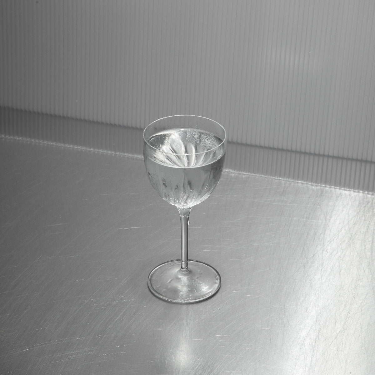 Chilled Gin Martini in a coupe glass with Amalfi lemon twist – minimalist cocktail serve